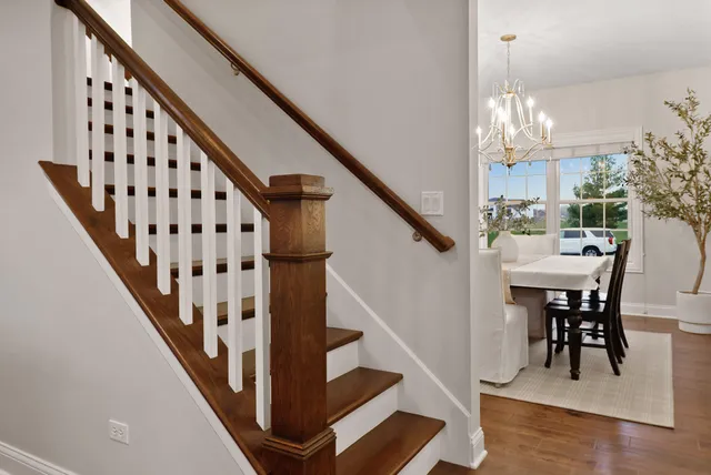 a view of entryway and hall with wooden floor