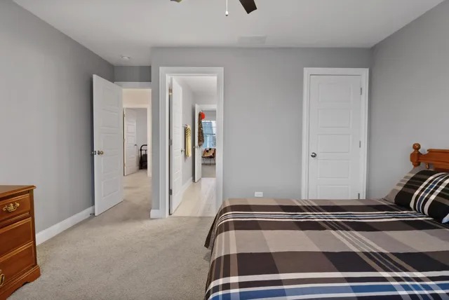 a bedroom with a bed and the view of bathroom