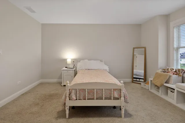 a bedroom with a bed and a chair