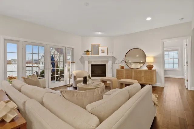 a living room with furniture a fireplace and a wooden floor