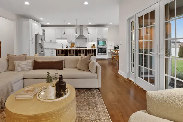 a living room with furniture and a kitchen