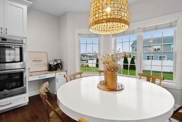 a kitchen with a stove and a white wooden cabinets