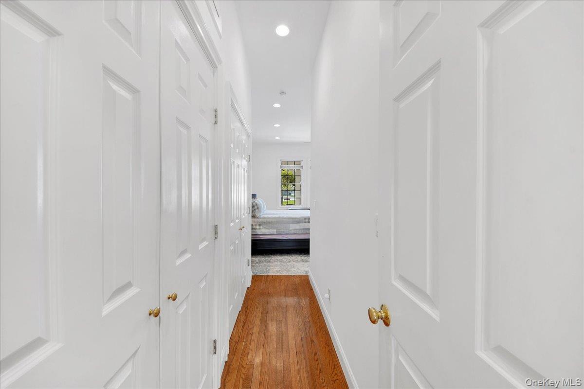 2 Harbor Lane, Unit 102 New Rochelle, NY 10805 - Photo 4 of 30 Hallway featuring hardwood flooring, white panel doors, recessed lighting, and a view into an adjoining room with a window