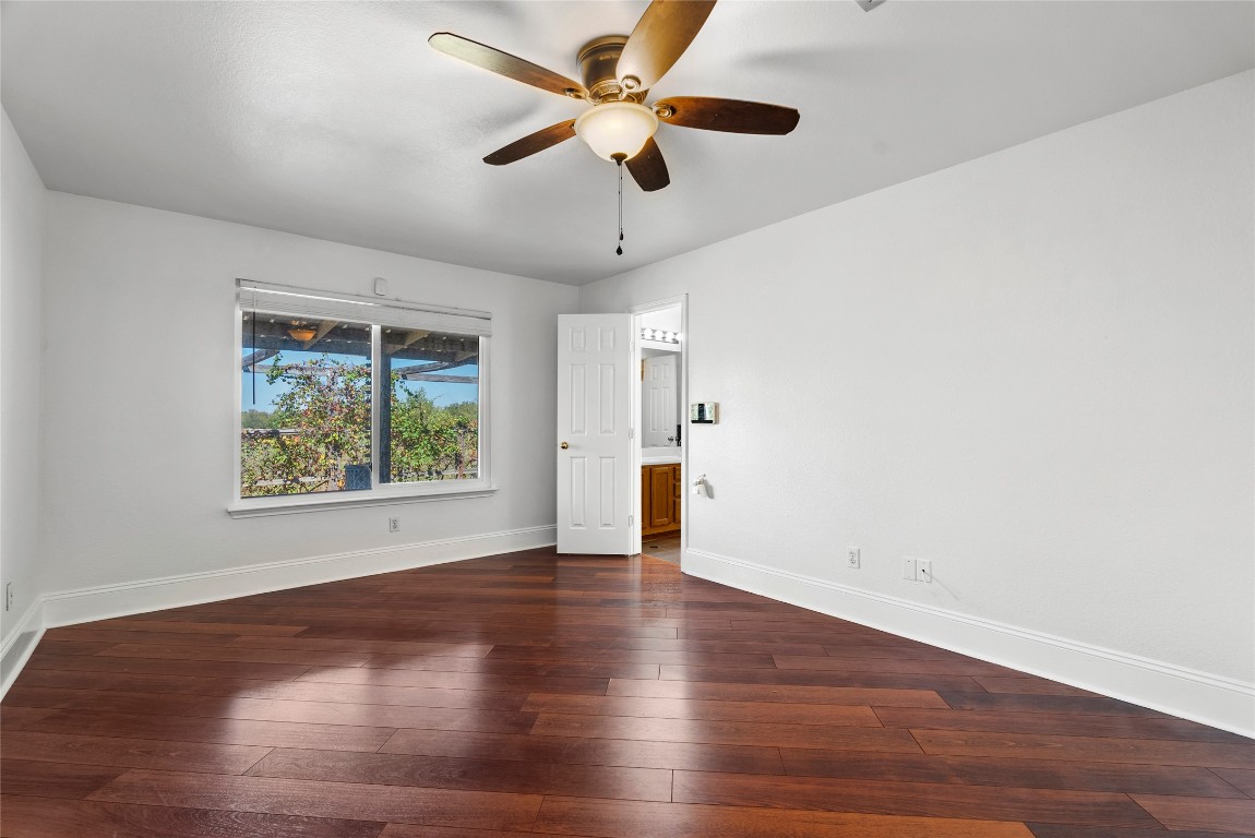 212 Valley Run Trail Elgin, TX 78621 - Photo 11 of 31 a view of an empty room with window and wooden floor