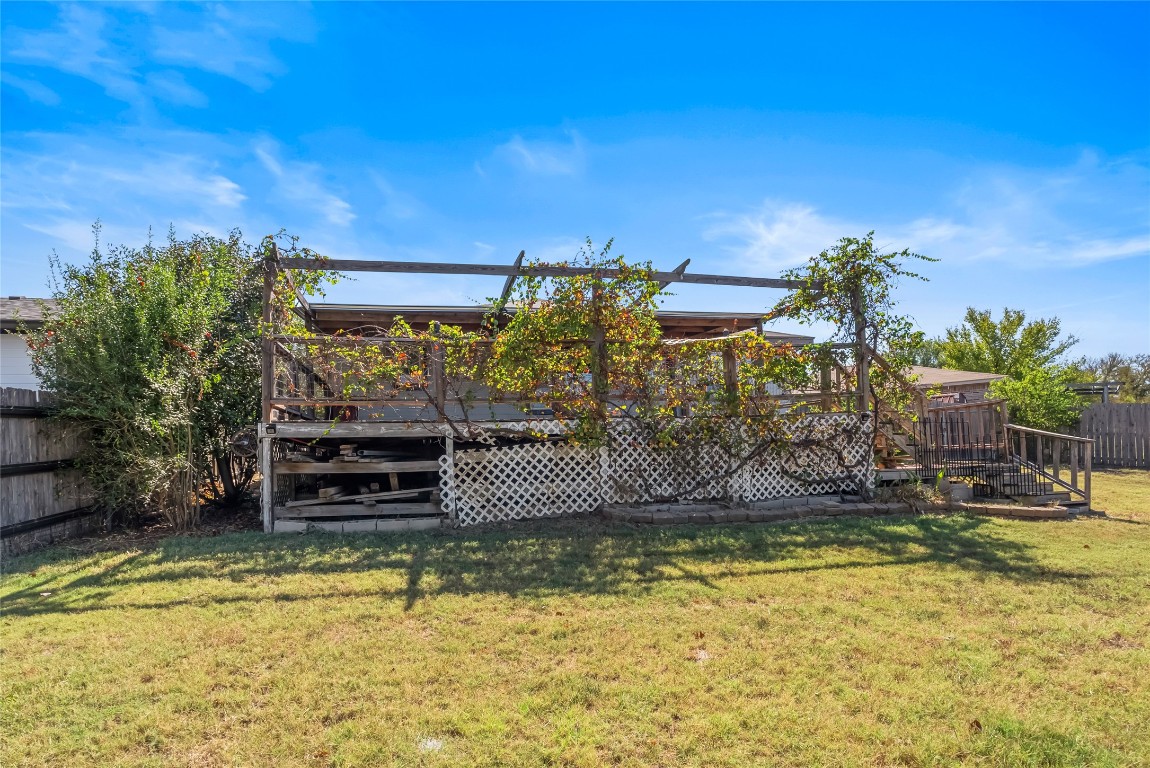 212 Valley Run Trail Elgin, TX 78621 - Photo 28 of 31 a view of a swimming pool with a lawn chairs under an umbrella