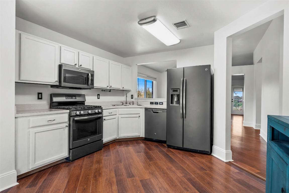 212 Valley Run Trail Elgin, TX 78621 - Photo 5 of 31 a kitchen with granite countertop a refrigerator stove and microwave
