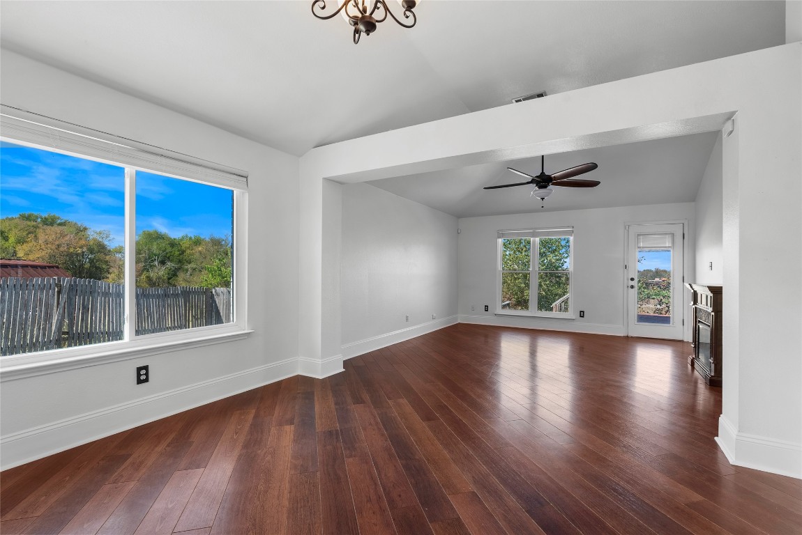 212 Valley Run Trail Elgin, TX 78621 - Photo 7 of 31 a view of an empty room with wooden floor and a window