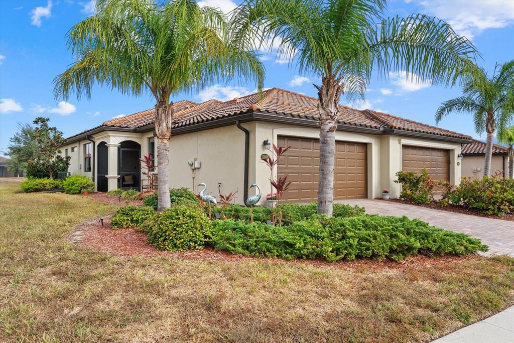 12588 Garibaldi Lane Venice, FL 34293 - Photo 1 of 1 a front view of house with yard and green space