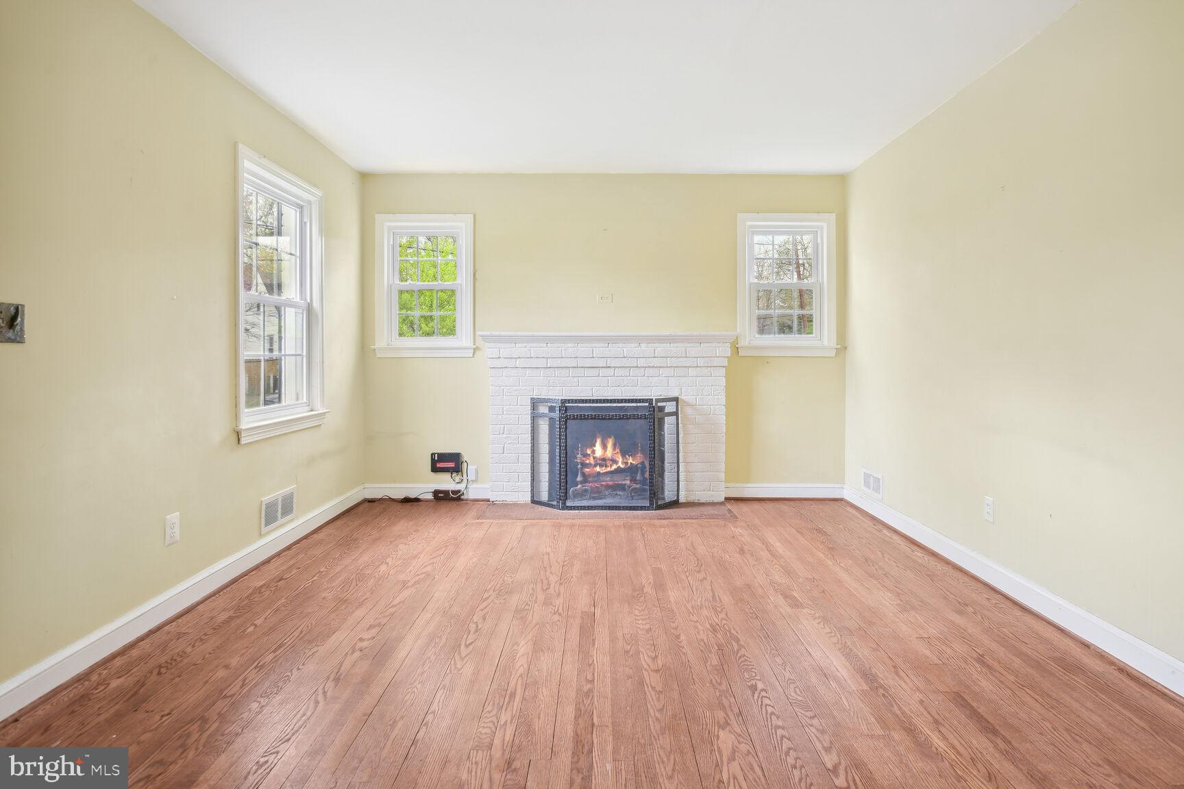 804 Dryden Street Silver Spring, MD 20901 - Photo 8 of 33 a view of an empty room with a window and fireplace