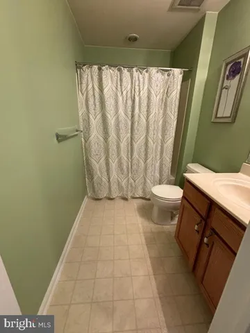 a bathroom with a granite countertop bathtub sink toilet and shower