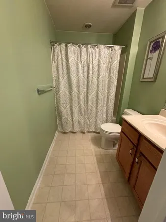 a bathroom with a granite countertop bathtub sink toilet and shower
