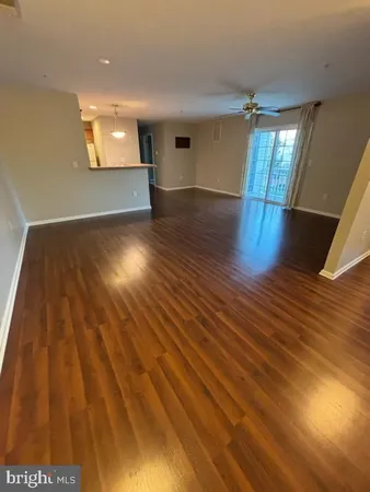 a view of an empty room and wooden floor