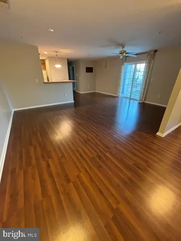 a view of an empty room and wooden floor