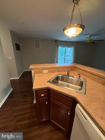 a kitchen with a sink and a refrigerator