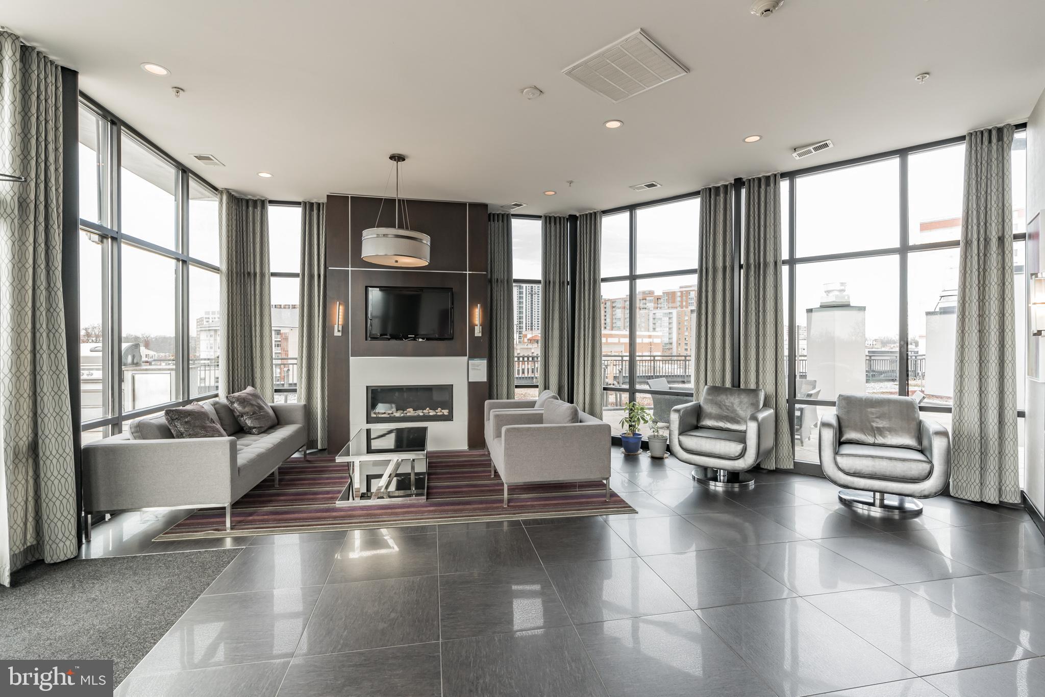 8005 13th Street, Unit 101 Silver Spring, MD 20910 - Photo 25 of 29 Glass enclosed lounge with fireplace