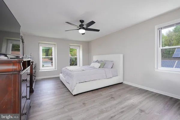 a spacious bedroom with a bed and a window