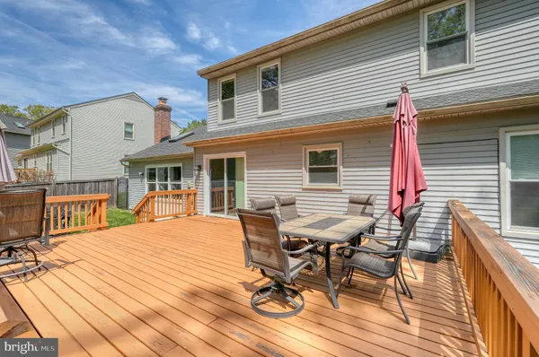 a view of a patio with table and chairs with wooden floor and fence