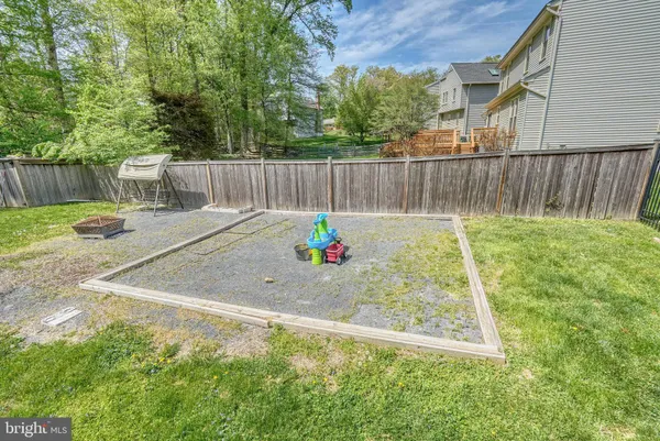 a view of backyard with wooden fence