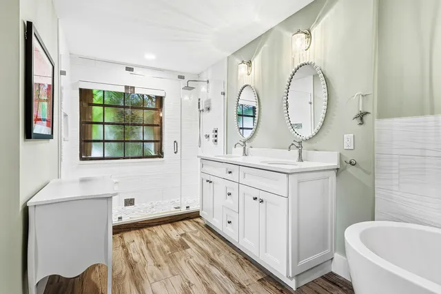 a bedroom with a bed a couch and a book shelf