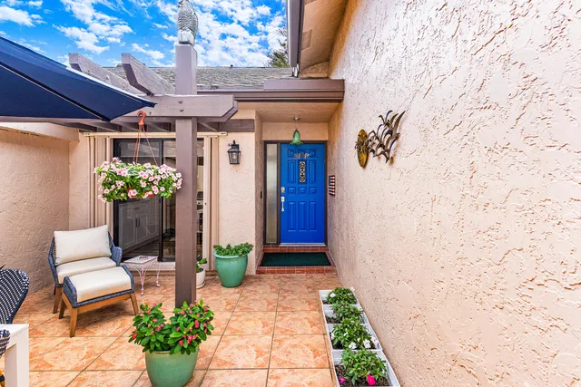 a front view of a house with a potted plant