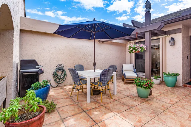 a view of a chairs and table in backyard
