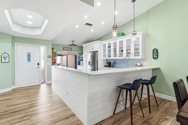 a kitchen with a stove and white cabinets