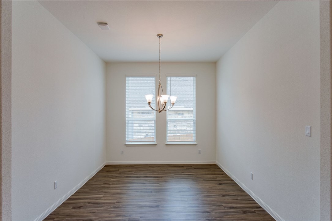 312 Prato Place Georgetown, TX 78628 - Photo 11 of 33 a view of an empty room with wooden floor and fan