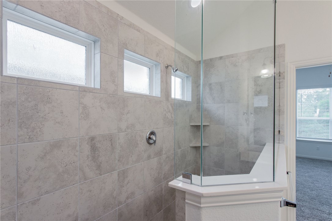 312 Prato Place Georgetown, TX 78628 - Photo 17 of 33 a bathroom with a shower and toilet