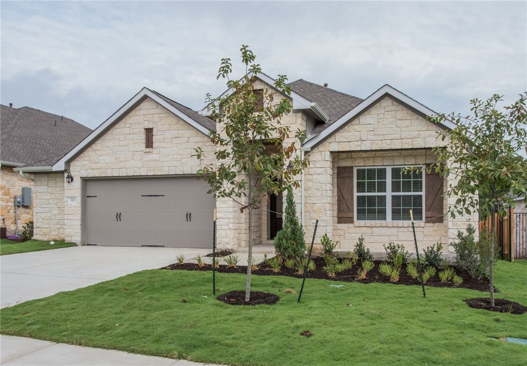 312 Prato Place Georgetown, TX 78628 - Photo 2 of 33 a front view of a house with a yard and garage
