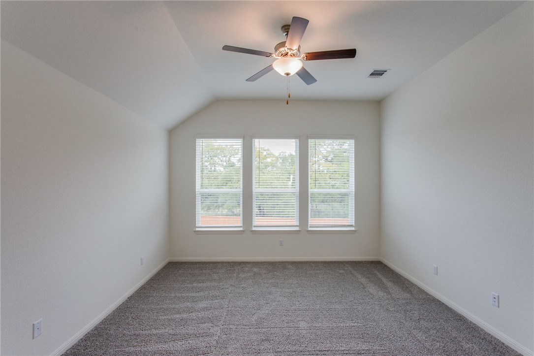 312 Prato Place Georgetown, TX 78628 - Photo 21 of 33 an empty room with a window and a ceiling fan
