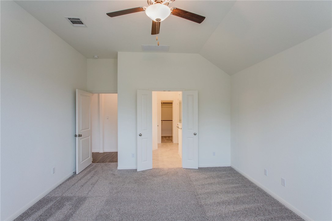 312 Prato Place Georgetown, TX 78628 - Photo 22 of 33 an empty room with a chandelier fan and windows