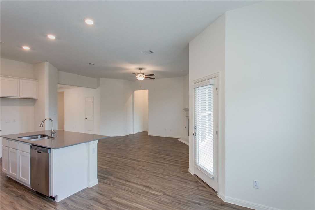 312 Prato Place Georgetown, TX 78628 - Photo 24 of 33 a view of kitchen with granite countertop cabinets and wooden floor