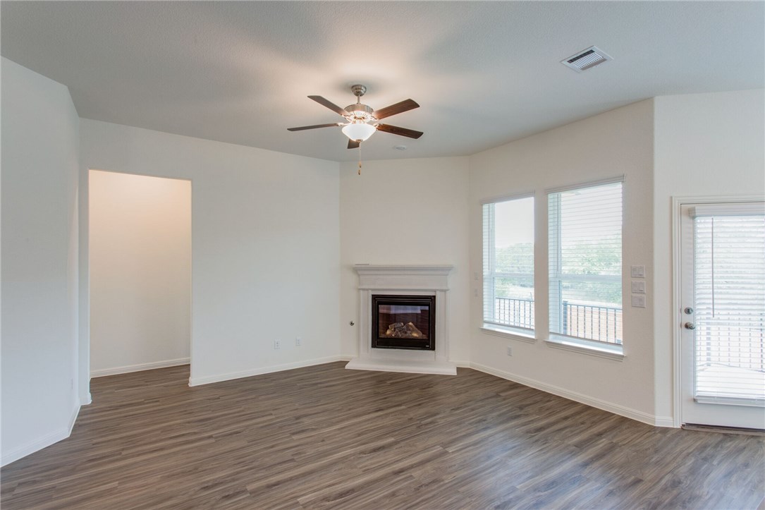 312 Prato Place Georgetown, TX 78628 - Photo 30 of 33 wooden floor fireplace and windows in an empty room