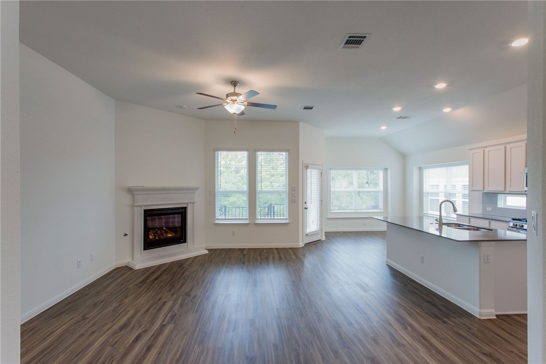 312 Prato Place Georgetown, TX 78628 - Photo 32 of 33 a view of an empty room with a fireplace and a window