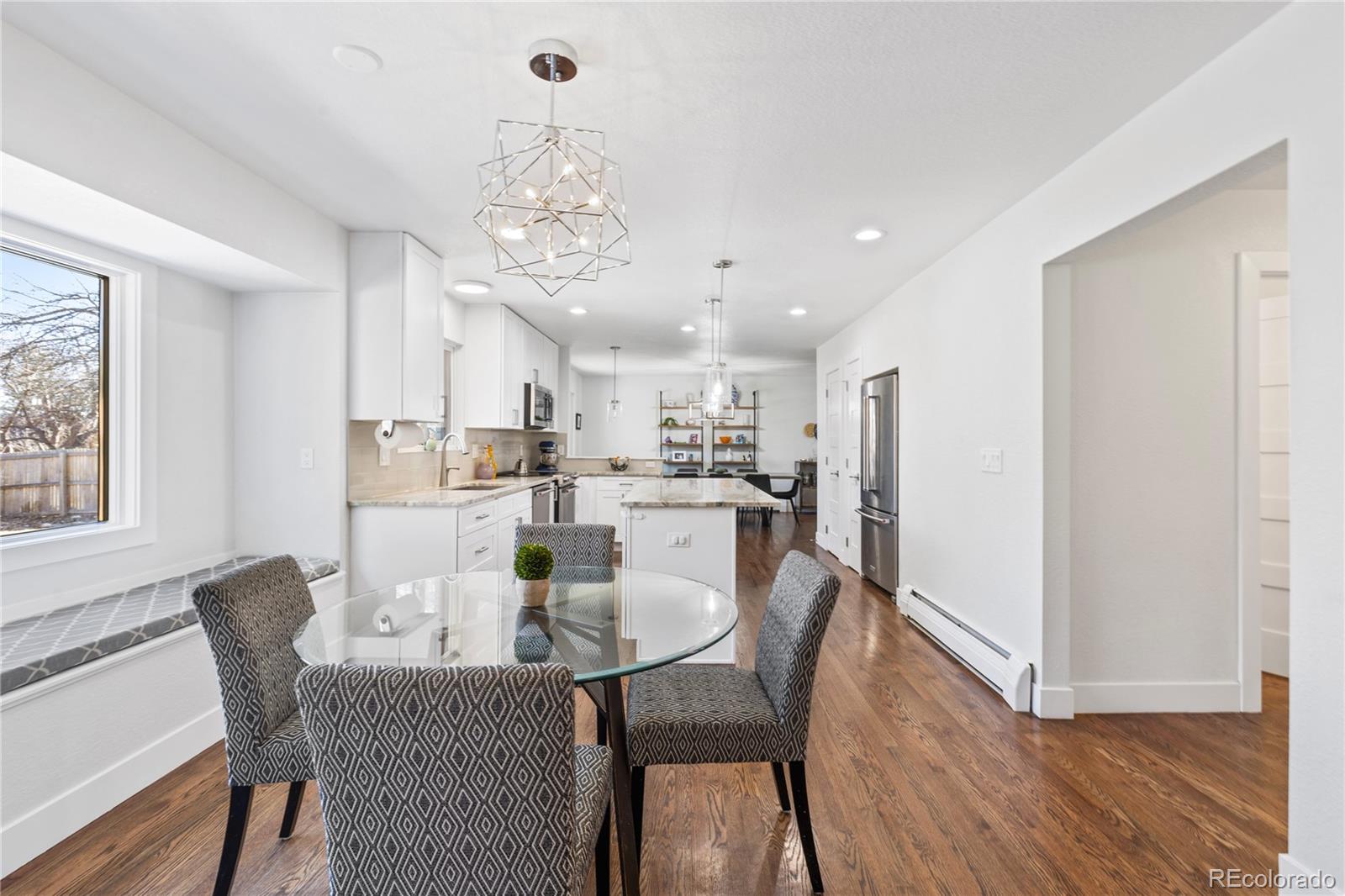 3764 South Niagara Way Denver, CO 80237 - Photo 14 of 50 a view of a dining room with furniture a chandelier and wooden floor
