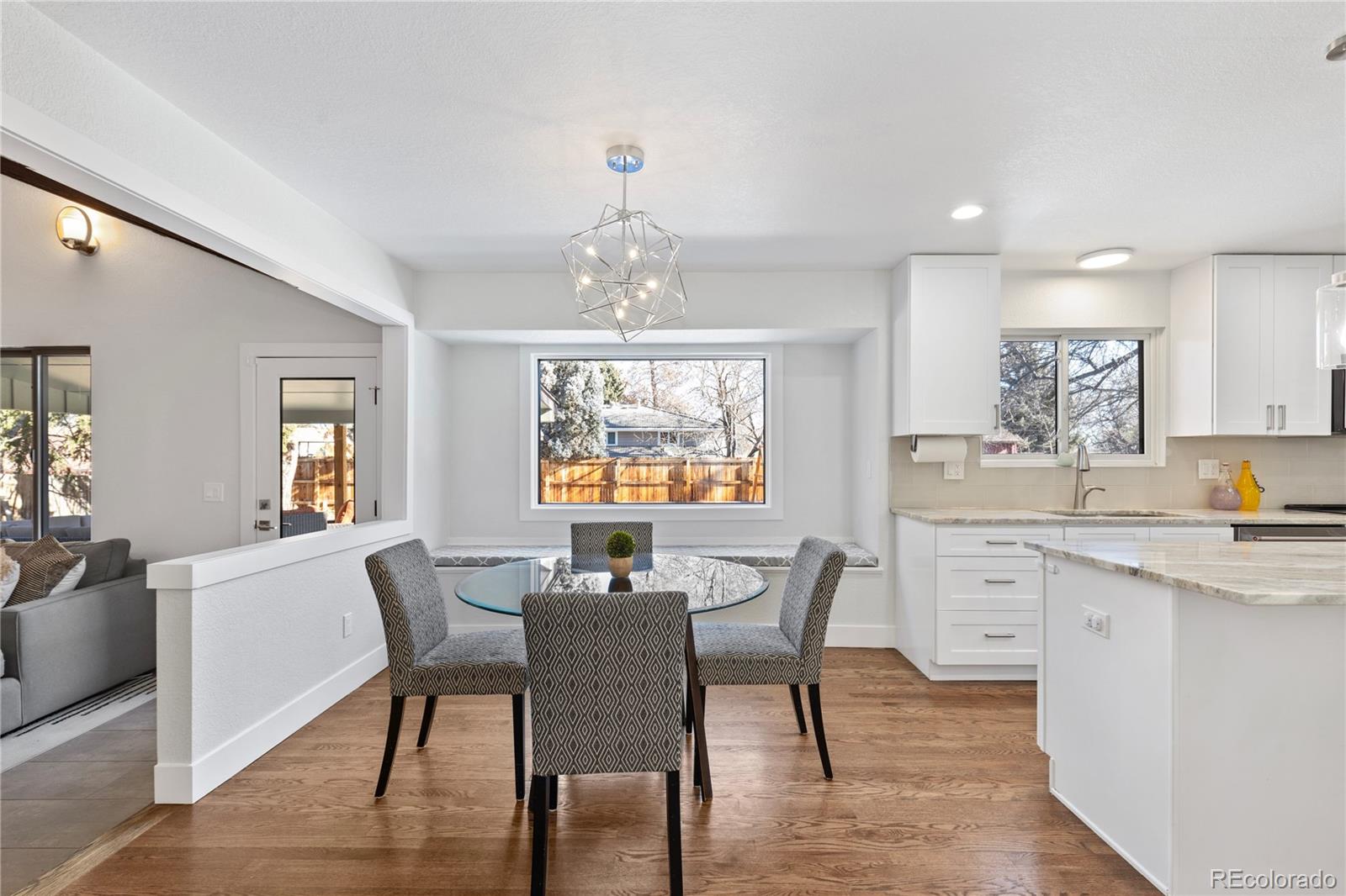 3764 South Niagara Way Denver, CO 80237 - Photo 15 of 50 a view of a dining room with furniture window and wooden floor