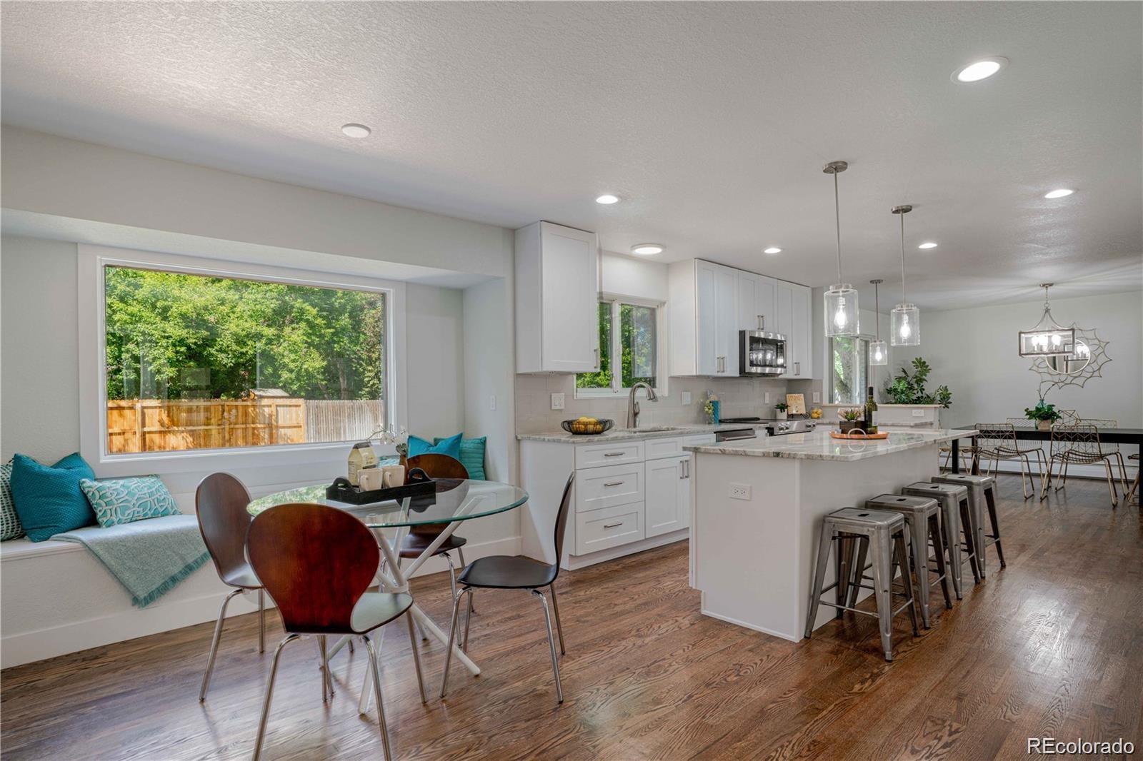 3764 South Niagara Way Denver, CO 80237 - Photo 17 of 50 a kitchen with a dining table chairs and window