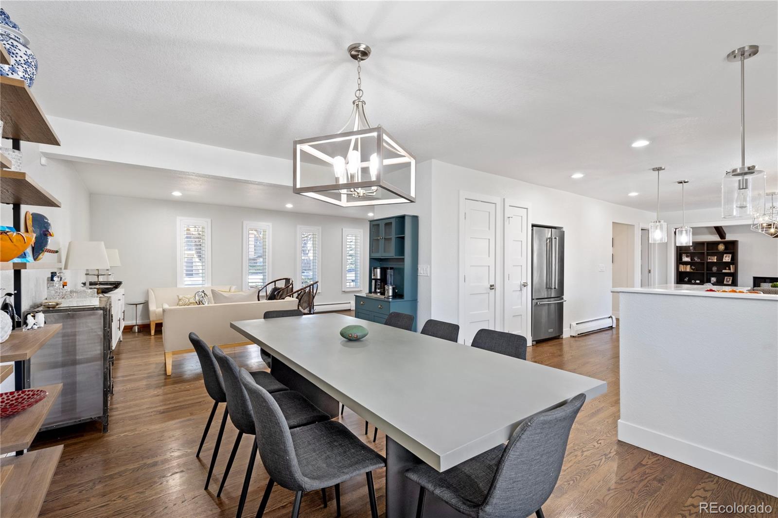 3764 South Niagara Way Denver, CO 80237 - Photo 18 of 50 a view of a dining room and livingroom with furniture wooden floor a chandelier