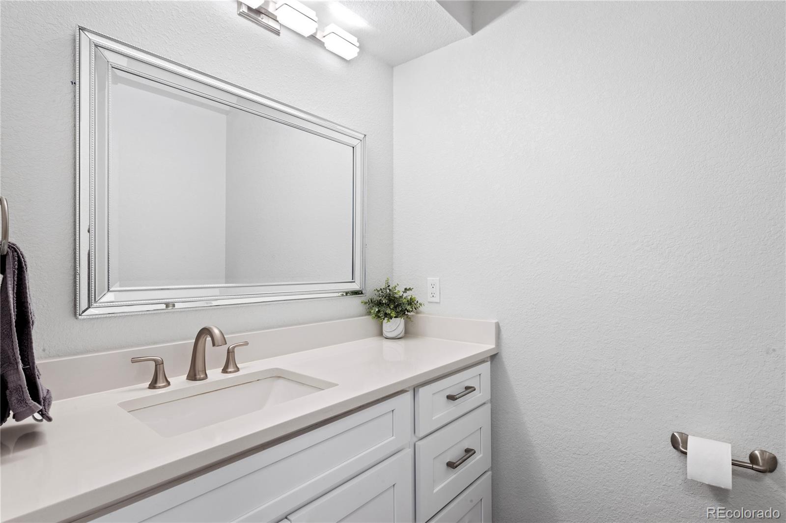 3764 South Niagara Way Denver, CO 80237 - Photo 27 of 50 a bathroom with a sink and a mirror