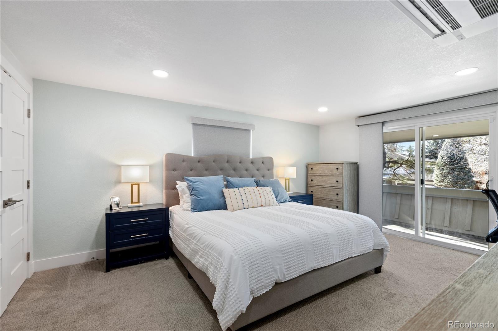 3764 South Niagara Way Denver, CO 80237 - Photo 29 of 50 a bedroom with a bed and a large window