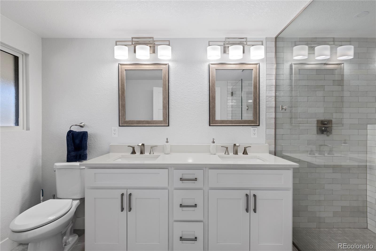 3764 South Niagara Way Denver, CO 80237 - Photo 31 of 50 a bathroom with a toilet sink and mirror