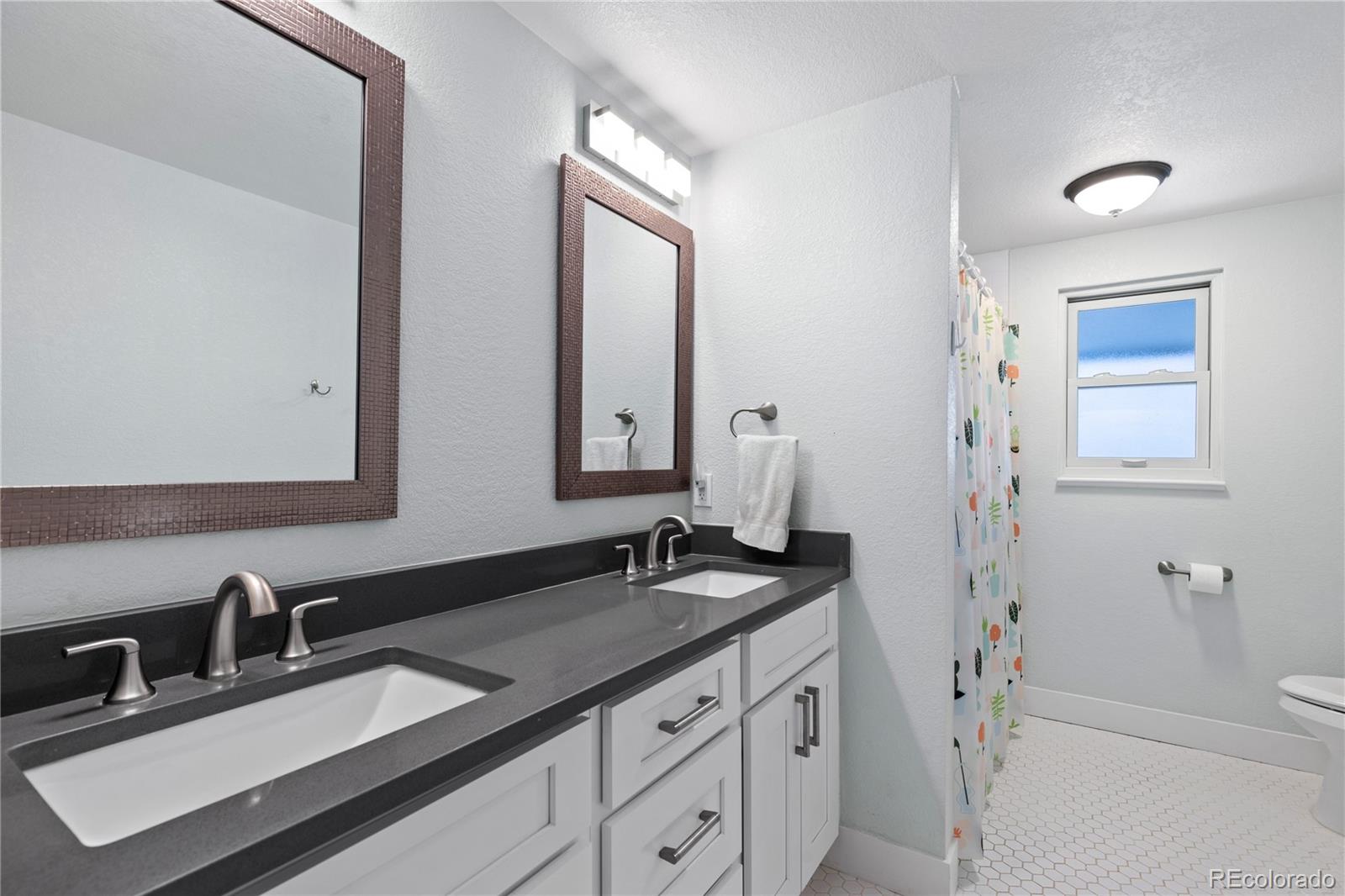 3764 South Niagara Way Denver, CO 80237 - Photo 35 of 50 a bathroom with a sink and a mirror