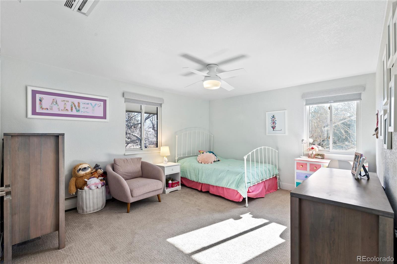 3764 South Niagara Way Denver, CO 80237 - Photo 36 of 50 a bedroom with bed and a chandelier