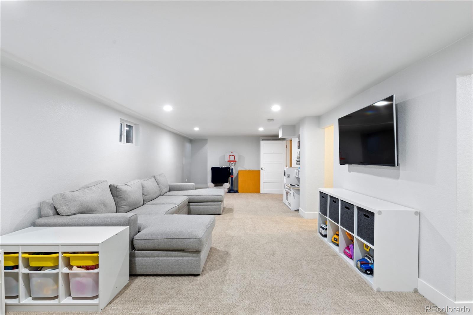 3764 South Niagara Way Denver, CO 80237 - Photo 39 of 50 a living room with furniture and a flat screen tv