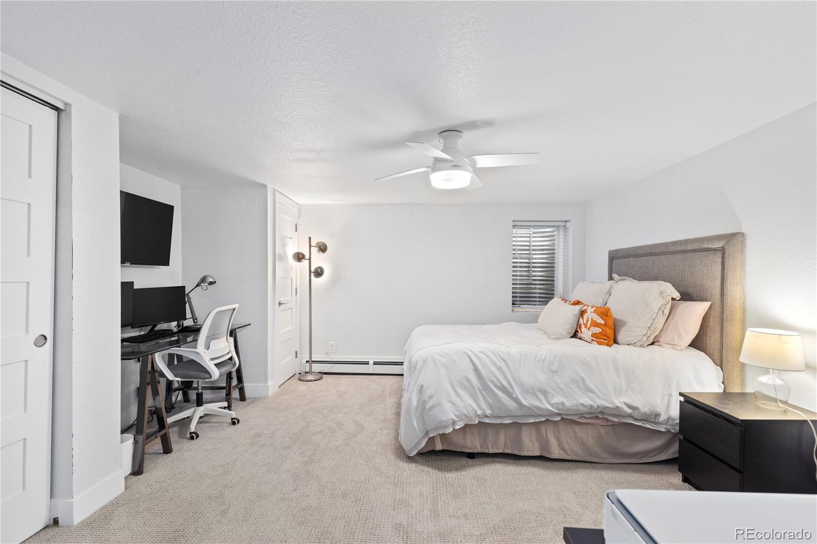 3764 South Niagara Way Denver, CO 80237 - Photo 40 of 50 a bedroom with a bed and a chandelier