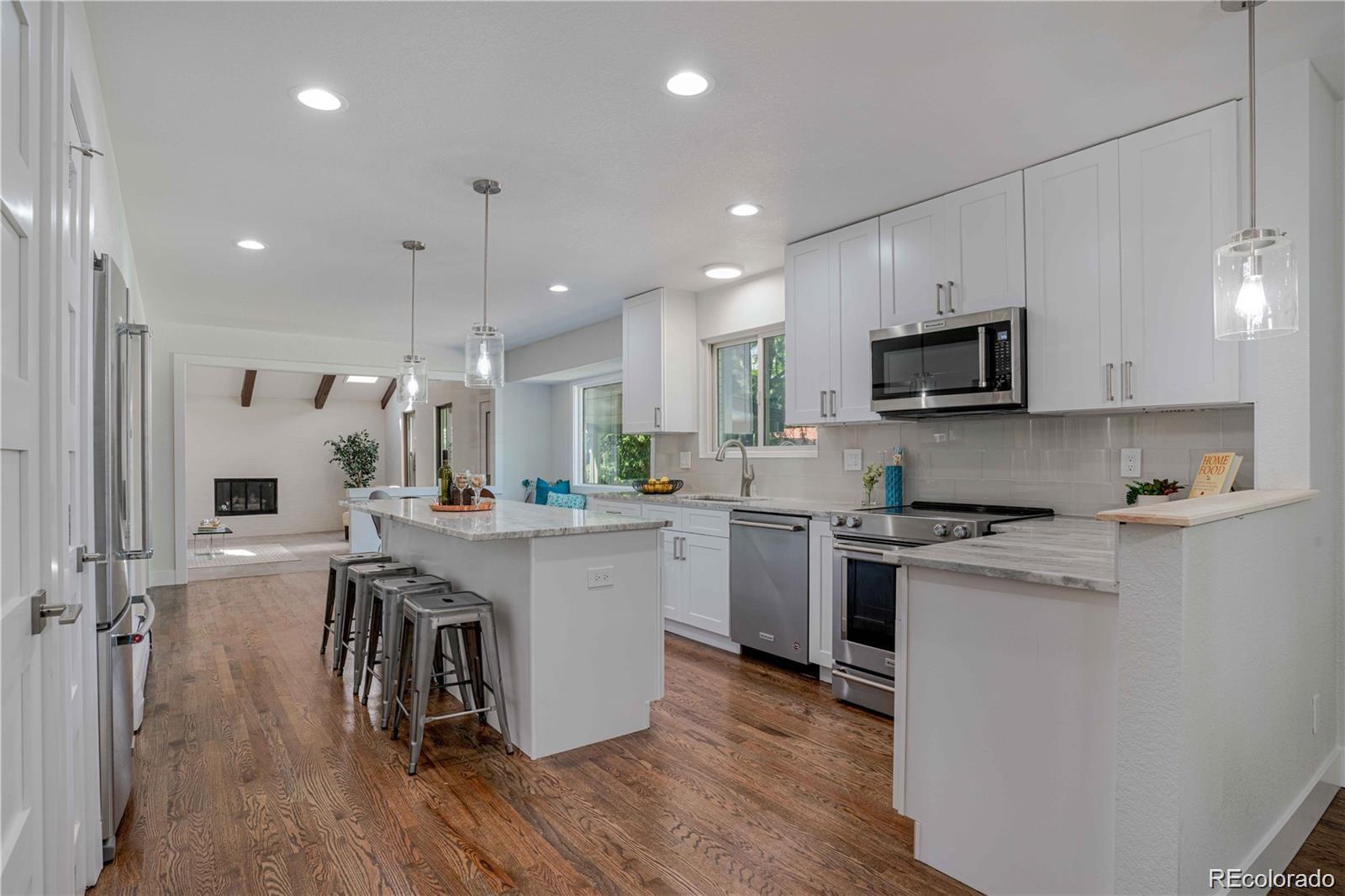 3764 South Niagara Way Denver, CO 80237 - Photo 4 of 50 a kitchen with a sink cabinets and wooden floor