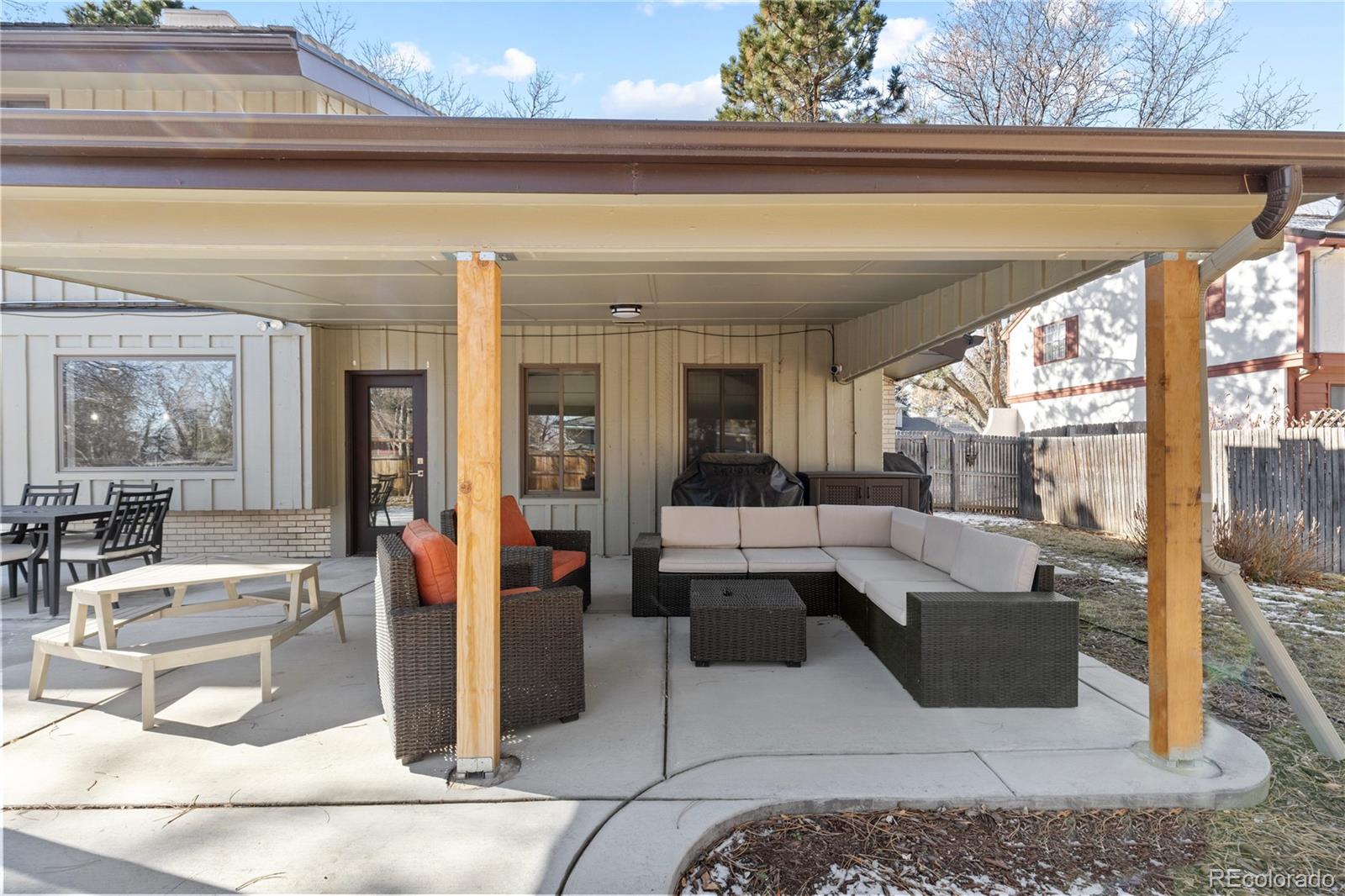 3764 South Niagara Way Denver, CO 80237 - Photo 48 of 50 a living room with couches and a dining table with garden view