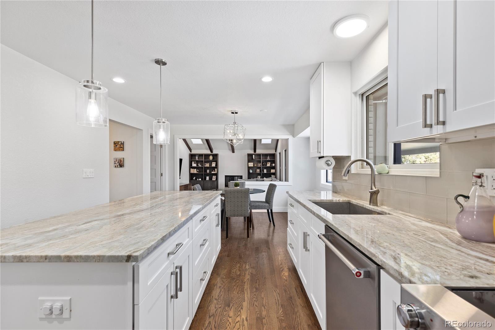 3764 South Niagara Way Denver, CO 80237 - Photo 6 of 50 a large kitchen with granite countertop a large counter top a sink stainless steel appliances and cabinets
