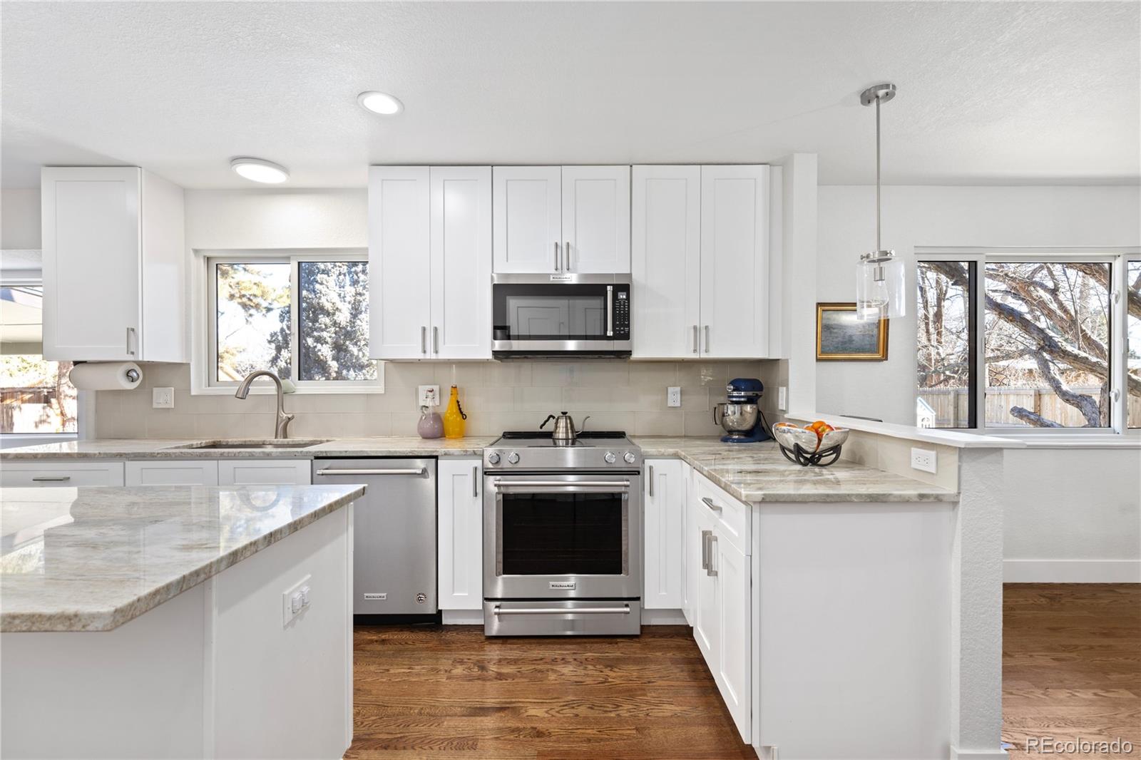 3764 South Niagara Way Denver, CO 80237 - Photo 7 of 50 a kitchen with stainless steel appliances granite countertop a stove sink and microwave