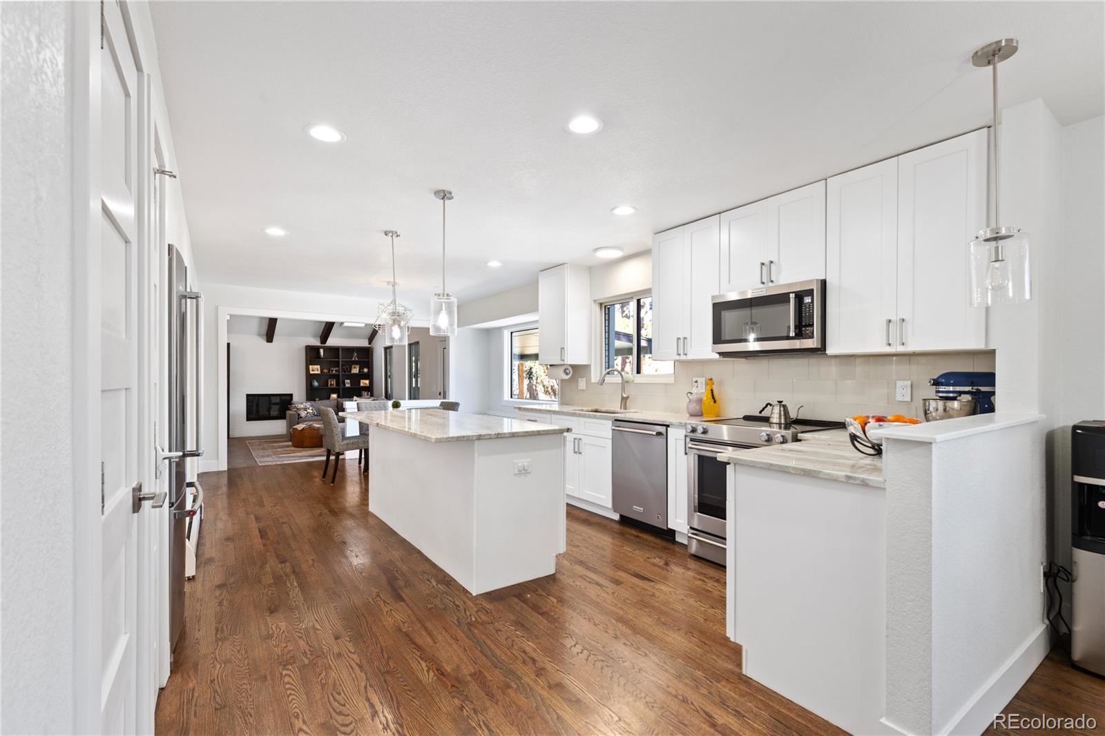 3764 South Niagara Way Denver, CO 80237 - Photo 8 of 50 a kitchen with white cabinets and stainless steel appliances